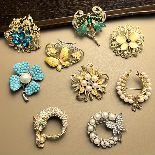 Collection of decorative brooches on a beige surface