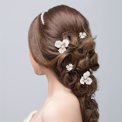 Woman with elegant hair styled in a braid with floral hair accessories on a light gray background