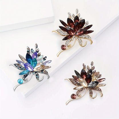 Three decorative brooches with gemstones on a white background