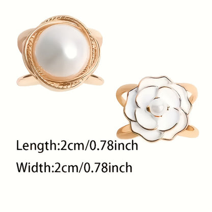 Two gold rings with pearls on a white background