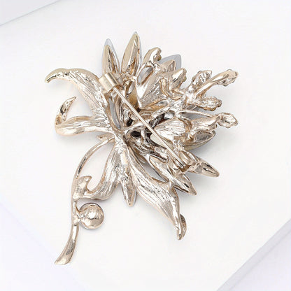 Silver floral brooch on a white background