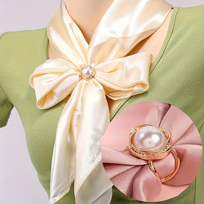 Woman wearing a green top with a large cream-colored bow and pink flower accessory on a white background