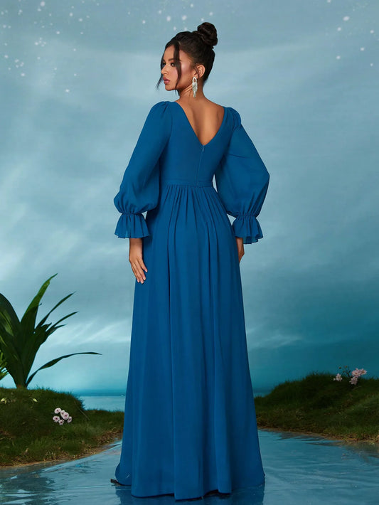 Woman in a blue dress standing on a path with a scenic background