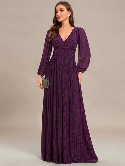 Woman wearing a long purple dress against a neutral background