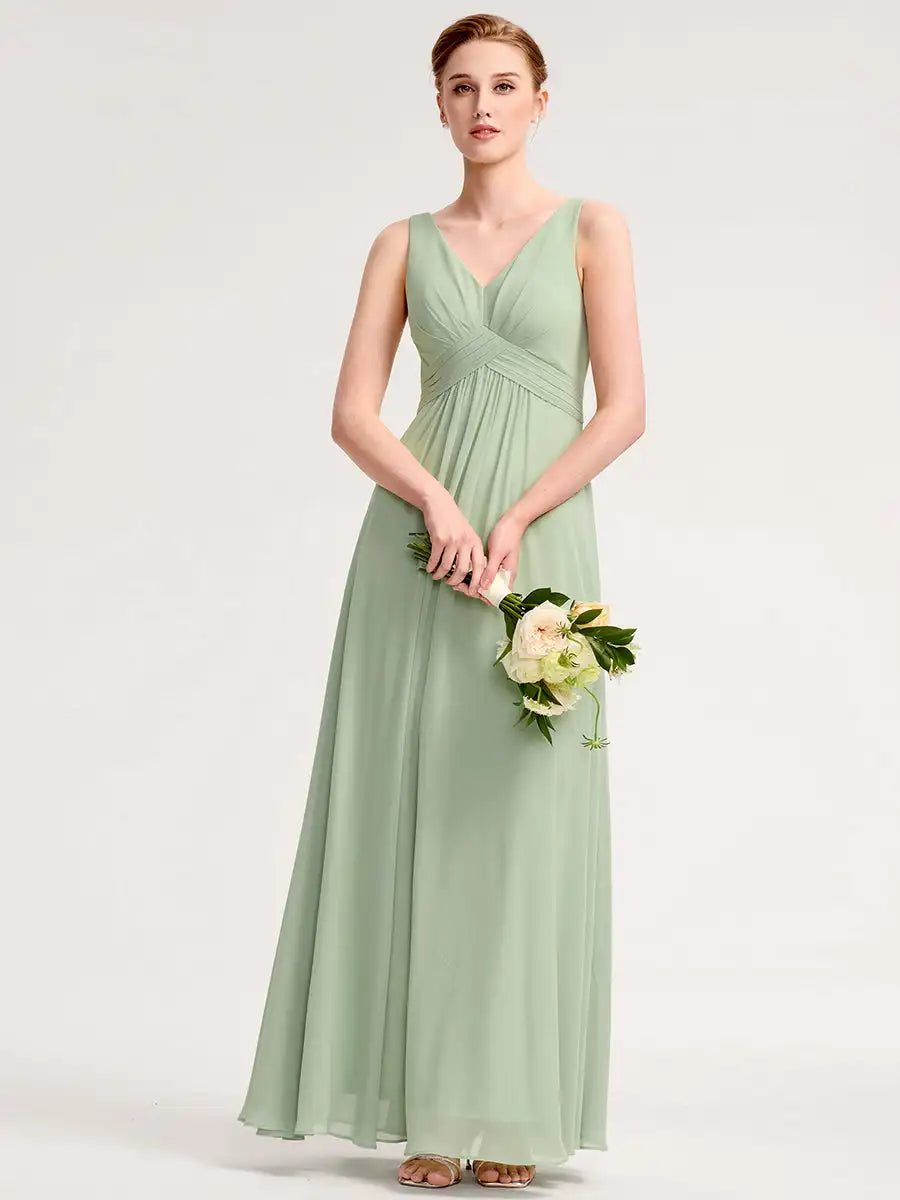 Woman wearing a long green dress holding flowers on a white background