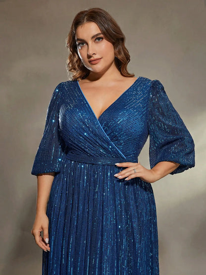 Woman wearing a blue glittery dress against a neutral background