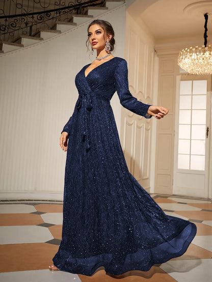 Woman wearing a navy blue evening gown in an elegant indoor setting.