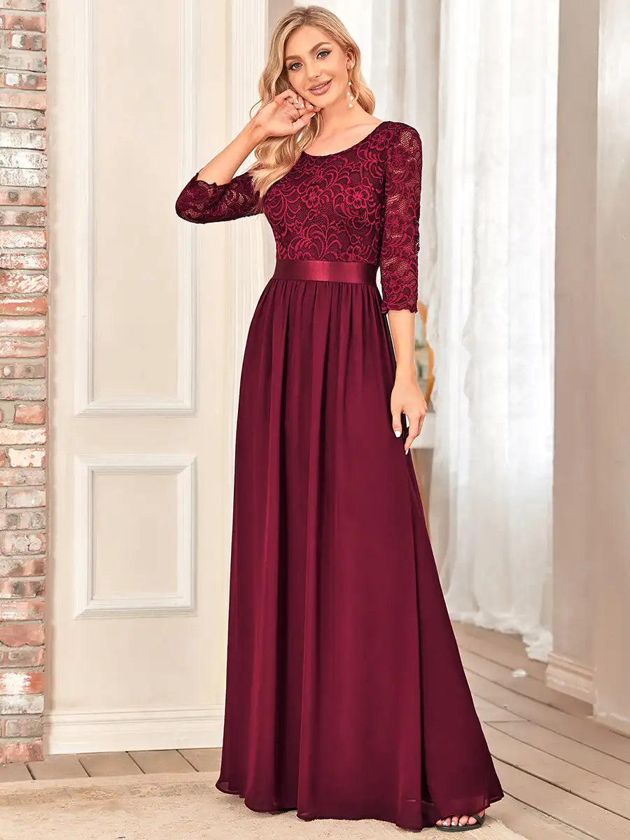 Burgundy evening gown with lace detailing on a white background