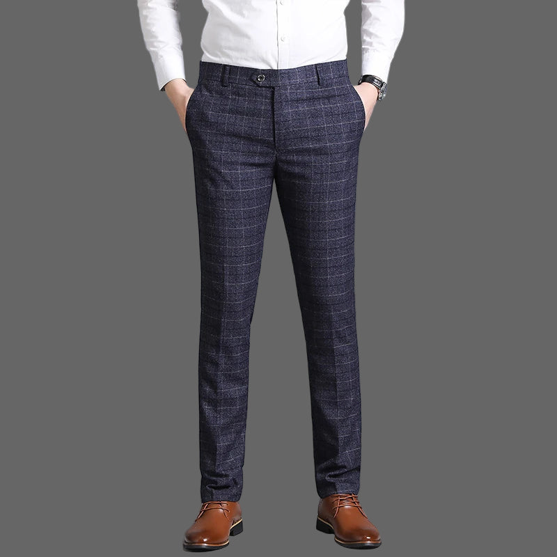 Person wearing dark plaid pants and a white shirt on a gray background