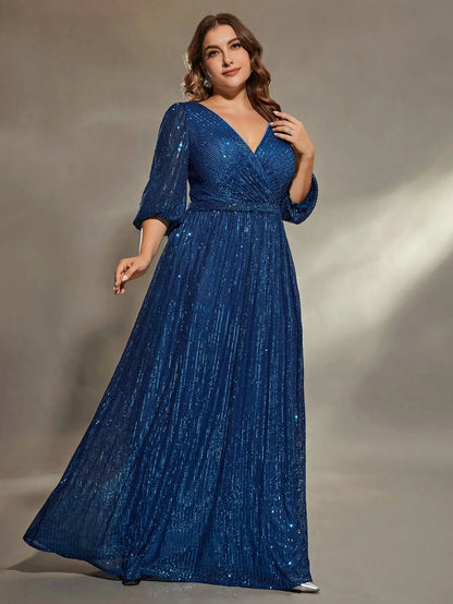 Woman wearing a blue glittery dress against a neutral background