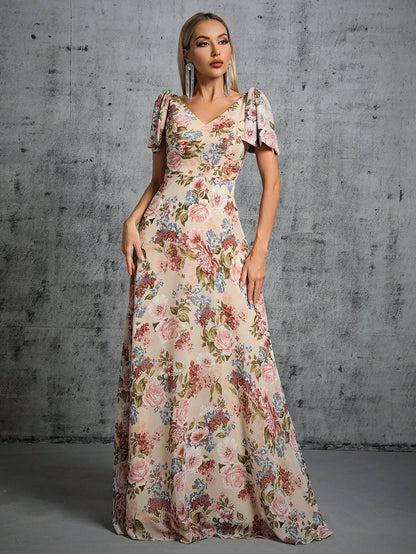 Woman wearing a floral dress against a gray concrete wall.