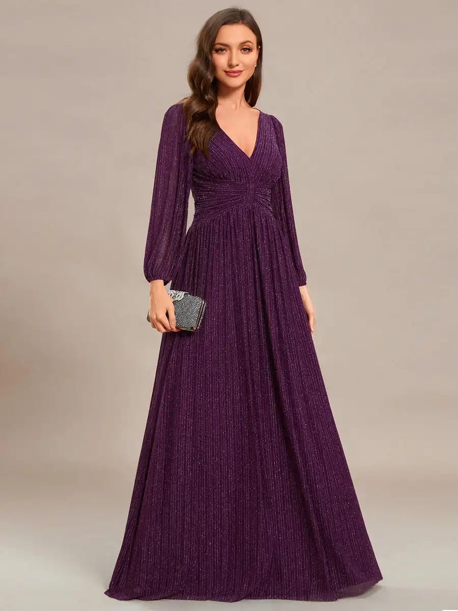 Woman wearing a long purple dress against a neutral background