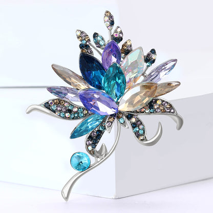 Multicolored gemstone brooch on a white background