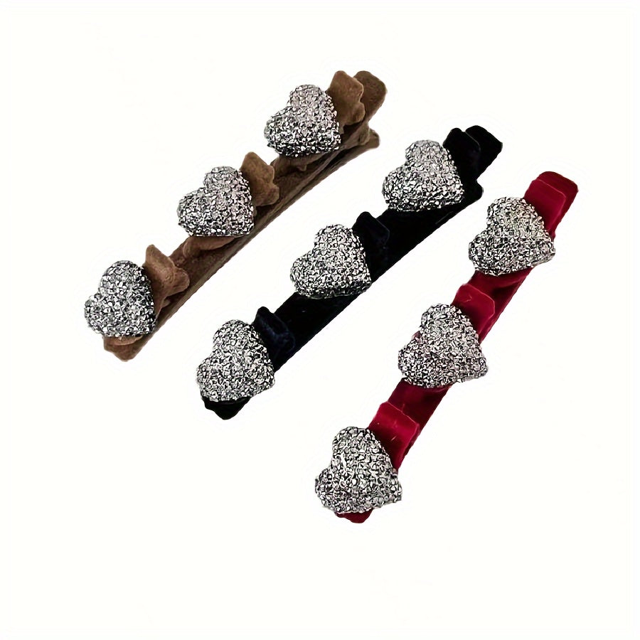 Three hair clips with decorative elements on a white background