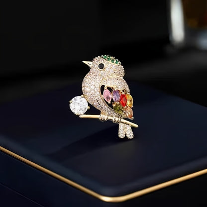 Decorative bird brooch with gemstones on a dark surface